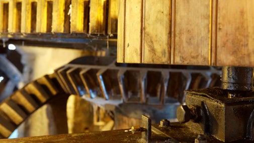 Close view of the wooden mill gearing at Winchester City Mill, Hampshire